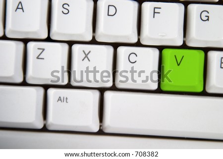 Isolated letter V on from a computer desktop keyboard highlighted in green
