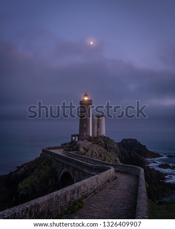 Similar – Leuchtturm an felsiger Küste am Meer