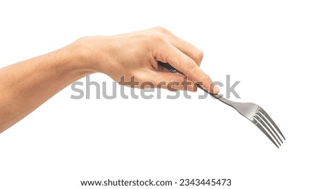 isolated of a man's hand holding a black steel fork to pick food.