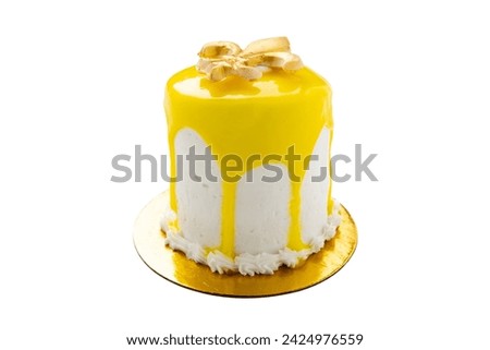 Isolated Mardi Gras vanilla mini cake with yellow icing pour has a gold fleur de lis on top. Quarter angle.