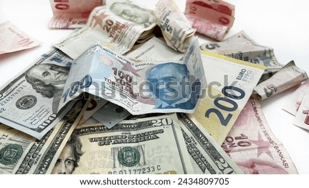 Isolated money on a white surface. Assorted Turkish lira notes paired with US dollars and euros.
