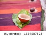 isolated Narial means coconut on betel leaf with arecanut. red and purple background. wedding puja important material