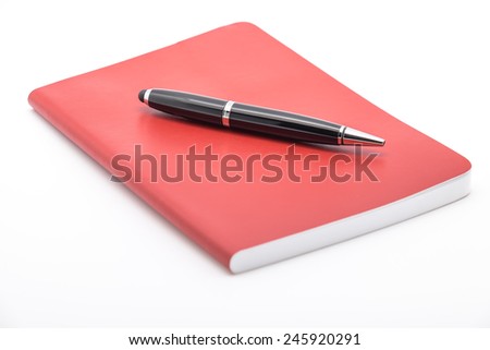 Isolated notepad or notebook with ballpoint pen for jotting down ideas and business plan on white background
