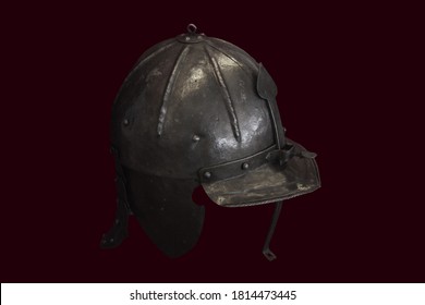 Isolated old military metal helmet on red background