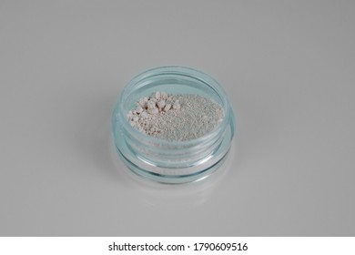 Isolated on light background makeup beauty cosmetics product & facial cosmetic, colourless mineral powder. Macro photo.
