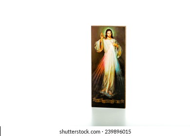 Isolated on white background, an icon with the picture of the Merciful Jesus: the translation of the Italian writing on bottom is Jesus, I trust in you