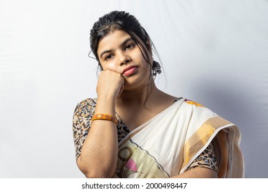 Isolated On White Background An Indian House Wife Wearing Saree In Thoughtful And Bored Look