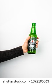 isolated on a white background, a woman's hand holding a bottle of Heineken's cold beer, Renningen,  Germany, 17.04.2019