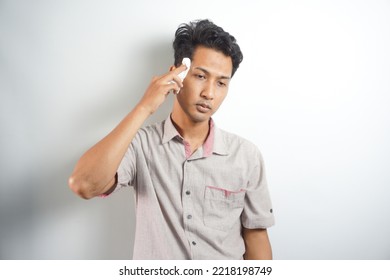 Isolated On White Studio Background Overheated Sweaty Young Man Suffering From Heat Stroke Or High Temperature, Using Paper Napkin. Head Shot Close Up Portrait Tired Millennial Guy Feeling Unhealthy.