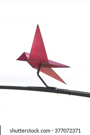 Isolated origami bird with stick on steel looks like flying with white background