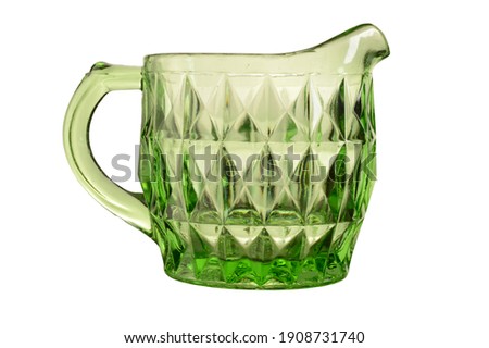 An isolated over white image of a Green Uranium Depression glass cream jug.