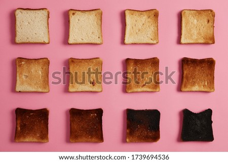 Similar – Image, Stock Photo Toasted toast bread in toaster on pink background