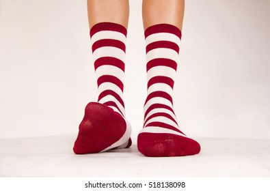 Isolated pair of striped white and red socks on white background