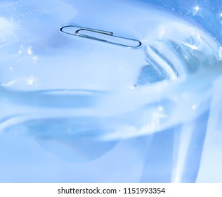 The Isolated Paper Clip In A Glass Of Water Floats On The Water Surface - Surface Tension Physical Laws