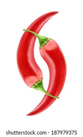Isolated peppers. Two red chili peppers in yin yang composition isolated on white background