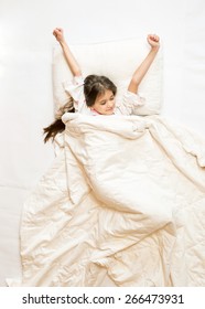 Isolated Photo Of Cute Girl Being Awake And Stretching In Bed