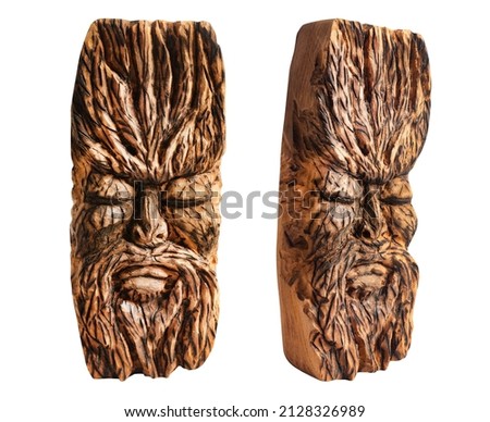 Isolated photo of fantasy face ancient pagan god totem idol carved in wood on white background.