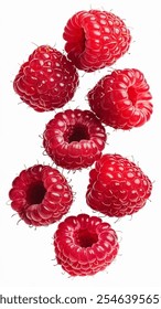 An isolated photo of five red raspberries falling down on a white background. 