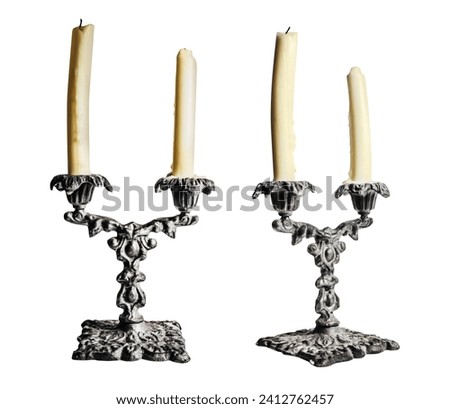 Isolated photo of old fashioned baroque style candlesticks with candles on white background.