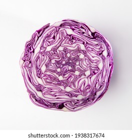 An isolated photo of sliced red cabbage from top. Close up of an intricate pattern of purple color cabbage after slicing it. Fresh vegetable cross section.
