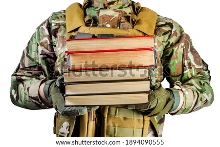 Isolated photo of a soldier in uniform holding stack of books on white background, front view.