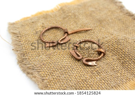 Isolated photos of a medieval copper fibula
