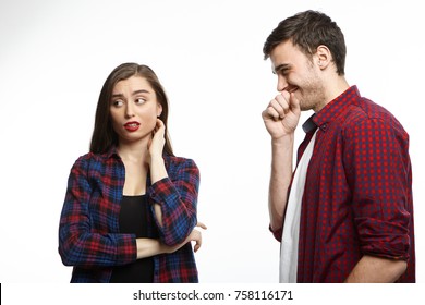 Isolated Picture Of Beautiful Young Female With Red Lips And Dark Hair Feeling Frustrated, Doesn't Know How To Escape From Annoying Guy Who Laughing At His Own Silly Jokes During First Date