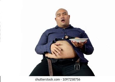 Isolated picture with white background of fat baldy man in tight blue shirt is  holding a glass of ice tea and plate of snack and eating it with pleasure.