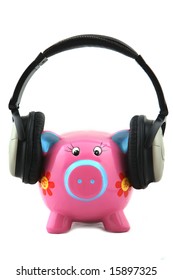 Isolated Piggy bank with headphone shot over white background.