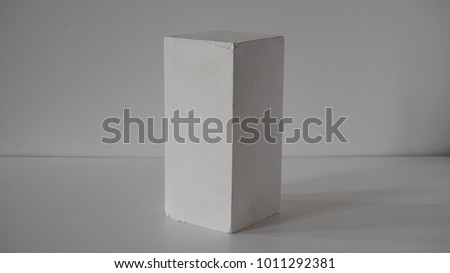 Isolated plaster cuboid with white background.