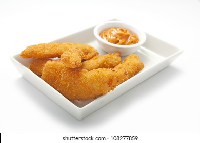 Isolated Plate Of Chicken Fingers With Mustard Sauce