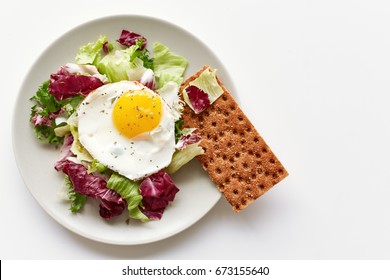 Isolated Plate With Healthy Breakfast Containing Fried Egg, Lettuce And Crispbread