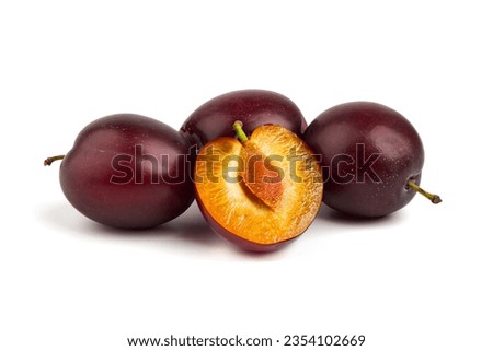 Isolated plums. One and a half of blue plum fruit, isolated on white background