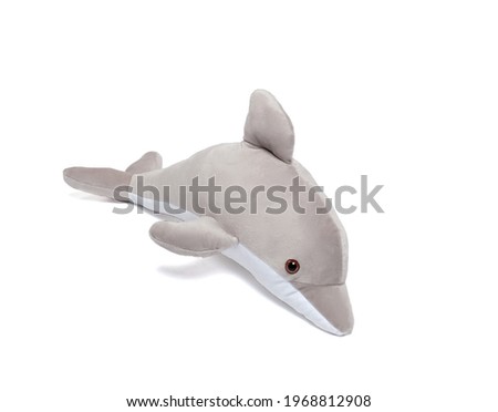 isolated plush dolphin soft toy on a white background. Children's little seafood.