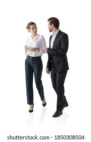 Isolated portrait of businesswoman and businessman walking together and talking. Concept of communication