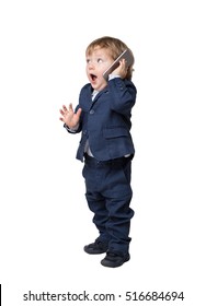 Isolated portrait of a cute little child talking on his smartphone and standing in a dark suit. Mock up