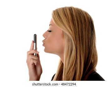 Isolated Portrait Of A Girl Kissing Her Phone