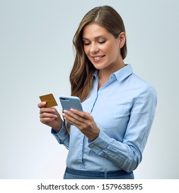 Isolated Portrait Of Woman Buys In An Online Store Using Credit Card And Smartphone. 