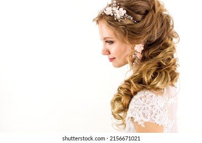 isolated portrait young blonde bride girl with cute hairstyle with jewelry in hair in wedding dress stands in profile on white background. wedding concept, free space - Shutterstock ID 2156671021