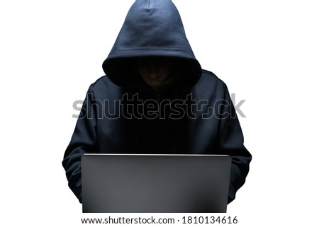 Isolated portrait of young hacker using laptop. Concept of cybersecurity and data protection