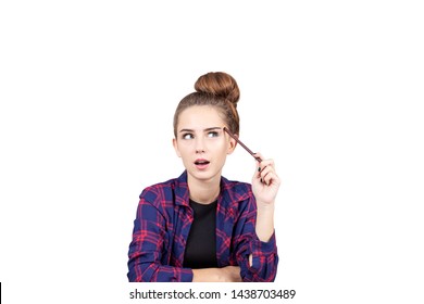 Isolated Portrait Of Young Woman Wearing Checkered Shirt And Thinking While Holding Marker. Concept Of Education And Design