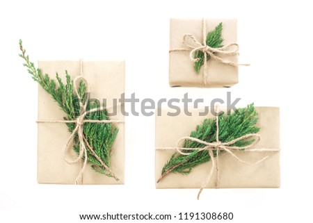 isolated present or gift box in craft paper with ribbon bow on white background. Top view, flat lay, overhead.