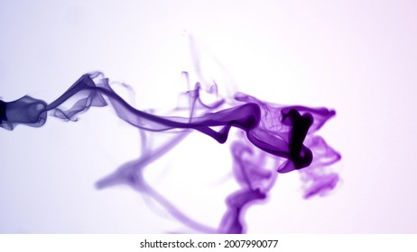 Isolated Purple Violet Ink Cloud floating in clear water. Macro Shot on White Background with selective focus framed for social media banner - Powered by Shutterstock