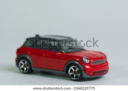 isolated red sporty toy car on white background , front view