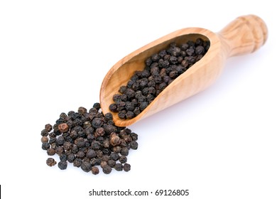 An Isolated Scoop And Black Peppercorns