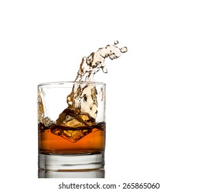 Isolated shot of whiskey with splash on white background