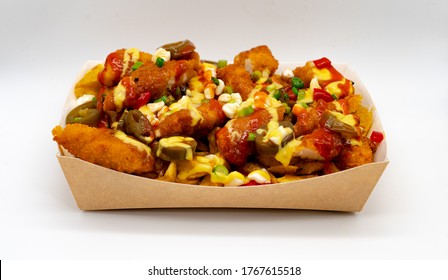 Isolated Skin On Fries Topped With Crispy Fried Chicken, Cheese And A Drizzle Of Sriracha In Cardboard Box