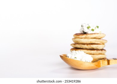 Isolated Slavic Food - Stack Of Pancake And Wooden Spoon With Sour Cream And Herbs 