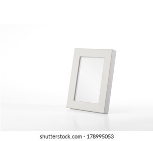 An Isolated Small Size, White Color Desk Photo Frame Without Picture In It. 