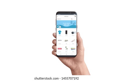 Isolated Smart Phone In Hand With Online Store App. Concept Of Flat Design App With Grab Deals Ad And Product Categories.